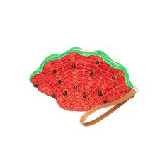 a small red and green purse sitting on top of a white surface