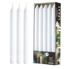 four white candles are in a box