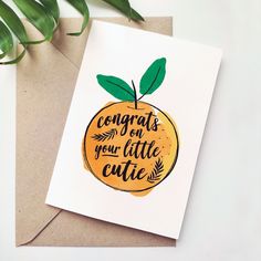 a card with an orange on it that says congrats on your little cutie