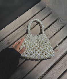 Zuruj Pearl & Crystal Handmade Bags Elegance in Every Detail Introducing the new line of luxurious handmade bags by Zuruj, meticulously crafted to bring timeless elegance to your collection. These exquisite bags are a perfect blend of pearls and crystals, reflecting the brand's commitment to quality and artistry. Features: - Handcrafted Masterpiece: Each bag is painstakingly handcrafted, ensuring that no two pieces are alike. - Luxurious Materials: Adorned with lustrous pearls and sparkling crys White Bags With Pearl Handle For Daily Use, Daily Use White Beaded Bags, White Handheld Bag With Pearl Handle, Pearl Handle Tote Bag For Gift, White Tote Bag With Pearl Handle, Gift Tote Bag With Pearl Handle, Pearl Purse, Pearl Clutch Bag, Pearl Handbag