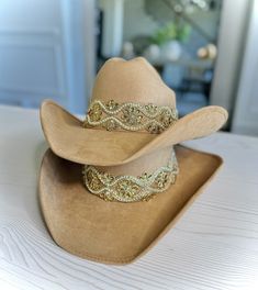 Get ready to make a statement with this Premium Suede Cowgirl Sombrero. Handmade in Mexico, this hat is a true testament to craftsmanship and quality. The soft suede material is perfect for any occasion, from casual outings with friends to formal events. The interior elastic band ensures a comfortable fit for all head sizes, while the silk linen adds an extra touch of luxury. This sombrero is not just a hat; it's an accessory that will elevate any outfit. Whether you're looking for protection from the sun or adding some flair to your style, this sombrero has got you covered. Its timeless design and premium materials make it an investment piece that will last for years. 7th photo: Brown is on top, dusty pink is on the bottom  Not a huge difference between them 💕 8th photo & 9th: brown hat Western Style Gold Fedora With Flat Brim, Western Gold Fedora With Short Brim, Western Style Gold Fedora With Short Brim, Adjustable Felt Hat For Kentucky Derby Country Events, Custom Felt Hat For Rodeo, One Size, Gold Fedora Western Hat, Gold Fedora Hat For Rodeo, Gold Western Fedora Hat, Adjustable Felt Country Hat For Rodeo