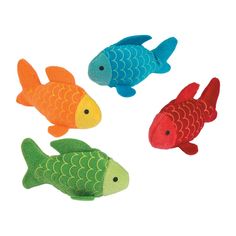 three colorful fish stuffed animals sitting next to each other on top of a white surface