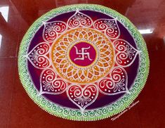 a colorful painted plate with the word om shan shan shan shan shan shan shan shan shan shan