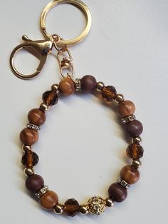 a beaded bracelet with a lion head charm is displayed on a white table top