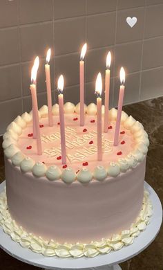 a birthday cake with many lit candles on it