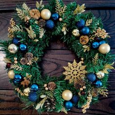 a christmas wreath with blue and gold ornaments