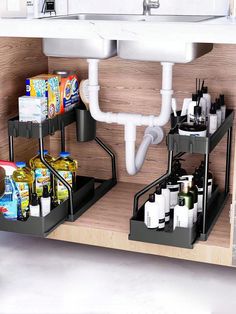 a kitchen sink with two black shelves underneath it and various cleaning products on the shelf