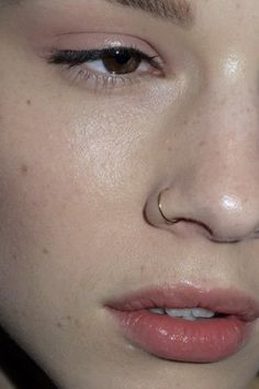 a close up shot of a woman's face with freckles on her nose