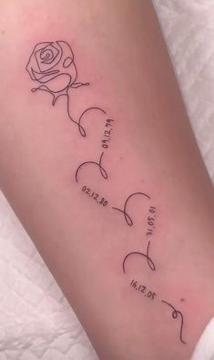 a woman's arm with the names of three different people and a rose on it