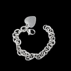 This is part of Chairish’s Costume Jewelry assortment.  Elegant Sterling Silver Link Bracelet with Heart – Perfect for Engraving  This sterling silver link bracelet with heart is a timeless piece that blends style with personalization. Crafted from high-quality sterling silver, this bracelet features open links with a charming heart charm, designed to be perfect for engraving a special message or initial. At 7.25 inches, it offers a versatile fit for most wrist sizes.  Weighing 29.4 grams, this Classic White Gold Heart Bracelets, Classic Heart Shaped White Gold Bracelet, Classic Silver Bracelet With Rolo Chain, Classic Silver Bracelets With Rolo Chain, Sterling Silver White Gold Charm Bracelet, White Gold Sterling Silver Charm Bracelet With Solid Links, Sterling Silver Heart Pendant Bracelet In White Gold, White Gold Sterling Silver Bracelet With Rolo Chain, White Gold Sterling Silver Heart Pendant Bracelet