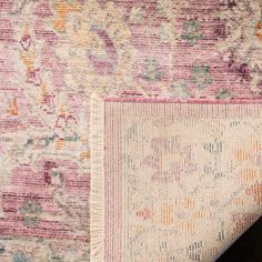 an area rug with various colors and patterns on it, including pinks, oranges, yellows and blue