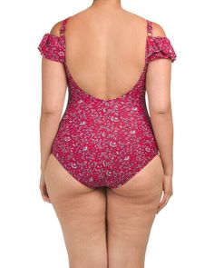 the back of a woman wearing a red floral print swimsuit