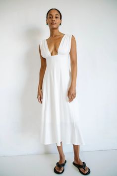 ELVA DRESS OFF-WHITE – The Line by K V-neck Dress With Ruched Bodice For Daywear, V-neck Dress With Ruched Bodice For Brunch, Ruched V-neck Fitted Bodice Dress, Fitted Maxi Length V-neck Dress For Daywear, Flattering V-neck Summer Dresses, Fitted V-neck Dress With Gathered Neckline, V-neck Midi Dress With Fitted Bodice, Fitted Empire Waist Maxi Dress For Brunch, Chic Fitted Maxi Dress With Notched Neckline