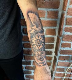 a man with a clock and rose tattoo on his arm