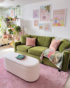 a living room with green couches and pink carpeted area rugs on the floor