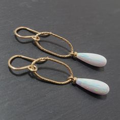 This beautiful pair of handmade earrings feature 2 White Opal gemstones. The earrings are handmade using nickel-free 14k Gold Filled or Sterling Silver. These earrings are simple and dainty, perfect for everyday wear. Makes a great gift to add to any gemstone lover's collection. Perfect to gift for Christmas, Valentine's Day, Mother's Day, and more! Gemstone: White Opal, Simulated Gemstone Size: 16.0 X 6.0 mm Metal: 14k Gold Filled or Sterling Silver (Hypoallergenic) Shape: Elongated Teardrop, H White Oval Minimalist Earrings, Minimalist White Oval Earrings, Classic Oval Teardrop Earrings As Gift, Classic Oval Teardrop Earrings For Gift, Handmade White 14k Gold Earrings, 14k Gold Oval Earrings For Everyday, Everyday 14k Gold Oval Earrings, White Teardrop 14k Gold Earrings, White 14k Gold Teardrop Earrings