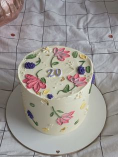 a white cake with flowers and numbers on it