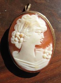 "Original Victorian cameo, circa 1860's, 18K Yellow Gold, Great Value, signed \"750\" in a diamond, Brooch and pendant Genuine shell cameo, face is carved by hand. Excellent condition. Measures: 1 1/16 x 3/4 inches." Victorian Oval Jewelry For Opera, Antique Carved Brooches For Weddings, Antique Cameo Brooches For Wedding, Heirloom Cameo Brooch For Wedding, Heirloom Cameo Wedding Brooch, Heirloom Cameo Brooches For Weddings, Victorian Style Cameo Brooch For Weddings, Victorian Cameo Brooch For Wedding, Victorian Cameo Jewelry For Anniversary