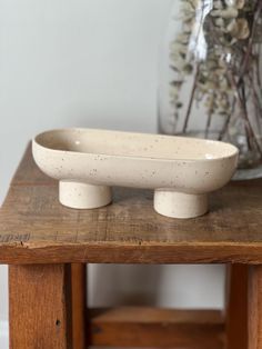 a white bowl sitting on top of a wooden table