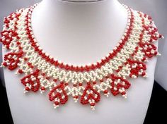 a red and white beaded necklace on a mannequin