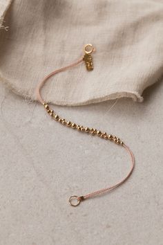 Our Leo Major Bracelet is a two-stranded silk cord adorned with an extended segment of detailed gold beadwork. 14k gold-filled beads and findings, silk cord. Complimentary gift packaging - handmade jewelry by Abacus Row in San Francisco California USA - bipoc Gelang Manik-manik, Embroidery Bracelets, Pola Gelang, Gelang Manik, Seni Origami, Beads Bracelet Design, Beaded Bracelets Diy, Cord Bracelets, Bead Jewellery