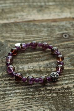 It is a perfect gift for your loved ones since it is a hand-made natural gemstone bracelet. It is a genuine Amethyst gemstone and handmade 925 sterling silver dragon head and Brand tag bracelet.  WE OFFER 100% NATURAL GEMSTONES CARVED FROM RAW STONES WHICH MAKES OUR PRODUCTS OF THE BEST QUALITY. We are small family jewelers located in Latvia, Europe, and we are proud that in our products, we use only genuine, natural, and unique gemstones. We spend so much time working with every single piece of gemstone and guarantee uniqueness and quality. About the Item Bracelet size: 19cm/7.5inch - We make/adjust the size you need. Amethyst beads size: 10mm and 6mm Material: Genuine unenhanced no dyed hand-carved from raw stone natural Amethyst. Amethyst Chakra: Crown Chakra. The Amethyst stone bracele Amethyst 8mm Beads Jewelry Gift, Amethyst Gemstone Beads Bracelets As Gift, Gift Amethyst Gemstone Beaded Bracelets, Amethyst Gemstone Beaded Bracelets As Gift, Amethyst Gemstone Beaded Bracelets For Gift, Amethyst Gemstone Beaded Bracelet Gift, Amethyst Bracelet With 8mm Beads, Silver Amethyst Beaded Bracelets For Meditation, Amethyst Beaded Bracelets With Natural Stones As Gift