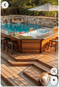 an above ground pool with steps leading up to it and a bar in the middle