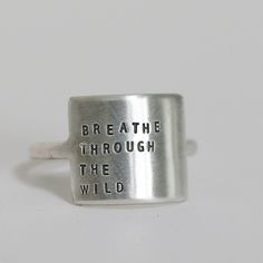 Because everyone needs a little reminder. Our Wide Ring makes a statement but is still delicate. Inspire yourself or inspire a friend. Letters are individually stamped by hand, making each ring one of a kind. The message is left justified in our signature teeny-tiny upper case block font. Choose one of our messages or create your own. details+ message plate measures 5/8" wide x 1/2" tall+ available in ring sizes 3 - 10.5 (whole & half sizes)+ handmade with love in our Georgia studio availability