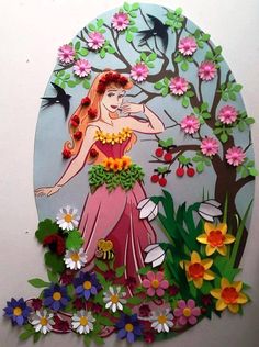 a paper cut out of a woman standing in front of a tree with flowers on it