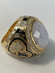 Lauren G Adams Crystal Enamel Renaissance Statement Ring Sz 9 New. Beautiful goldtone ring with a center bezel set oval milky white crystal and clear crystal halo. Sides are done in black and pearlized white enamel hearts with a fleur de lis design and squares. Size 9 1 1/8” by 1 “ 1 1/8” tall New unworn condition Ships in Lauren G Adams gift box and pouch Moonstone Rings, Antique Jewelry Rings, Jewelry Fashion Trends, Milky White, White Crystal, Moonstone Ring, Men's Rings, White Enamel, Vintage Watches