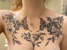 a woman's chest with flowers and butterflies on it