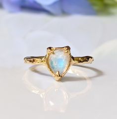 Show your special Love with our delicate Moonstone ring. Handcrafted in wax and cast in your choice of Solid Sterling Silver or Solid 14k Gold, our ring features a stunning Pear shape rainbow Moonstone - also the birthstone for June - and artfully set by prongs on an organic textured band, ensuring its uniqueness.  T H E ∙ S M A L L ∙  D E T A I L S * Pear shape rainbow Moonstone (6 x 8mm) * Solid 14k Gold textured band M A T E R I A L ∙ O P T I O N S * Sterling Silver * Solid 14k Gold You will receive a ring very similar to the one posted in this listing but it might differ slightly as all my rings are individually custom handcrafted for each buyer. No two settings are alike and this is what makes each of my rings unique!  S H O P ∙ M Y ∙ B R I D A L ∙ C O L L E C T I O N https://etsy.me/ Unique 14k Gold Moonstone Ring Gift, Handmade Delicate Moonstone Promise Ring, Untreated Recycled Gold Jewelry As A Gift, Delicate Hand Forged Ring As A Gift, Recycled Gold Untreated Jewelry As A Gift, Untreated Recycled Gold Jewelry Gift, Delicate Hand Forged Rings As Gift, Unique Yellow Gold Moonstone Ring For Anniversary, Hand Forged Moonstone Jewelry For Promise Ring