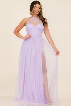 a woman wearing a lavender colored dress with sheer neckline and thigh high slits