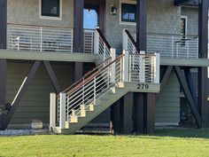 an apartment building with two balconies and stairs