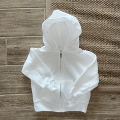 Classic White Zip Up Hoodie, No Tags But Brand New Casual Outerwear With Adjustable Hood For Playtime, Cotton Hoodie With Adjustable Hood For Playtime, Basic Hooded Outerwear With Ribbed Cuffs, Adjustable Hood Hoodie For Playtime In Fall, Playtime Hoodie With Adjustable Hood, Cotton Outerwear With Adjustable Hood For Playtime, Cotton Hooded Hoodie For Playtime, White Zip Up, Cotton Playtime Hoodie Outerwear