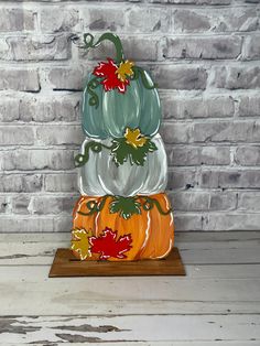 three glass pumpkins stacked on top of each other