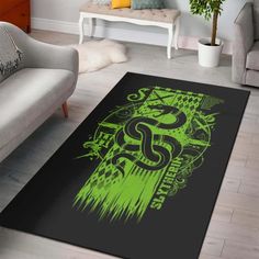 a living room area rug with a green and black design on the floor next to a couch