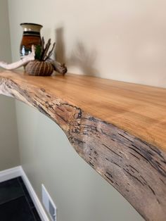 a close up of a wooden table with a vase on it