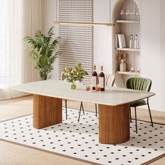 a dining room table with two chairs and a potted plant