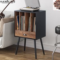 a record player sitting on top of a wooden cabinet