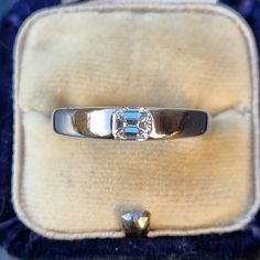 Beautiful & elegant solitaire 18ct white gold band, set with a 0.42ct emerald cut diamond in a flush half-bezel setting. The diamond is superb quality, very clear, bright and sparkly. The ring is in great condition, minimal signs of wear. Diamond: 0.42ct, clarity VS, colour G-H, emerald cut. Width: 3.7mm at the widest point. Hallmark: Maker's mark is rubbed, possibly reads as 'C&F', gold crown symbol, '750' for 18ct gold assay London, date letter 'a' for 2000, millennium 2000 mark Size: UK L1/2, Luxury Emerald Ring With Tension Setting For Formal Occasions, Modern White Gold Emerald Ring For Formal Occasions, Formal Platinum Emerald Ring With Diamond Cut, Modern White Gold Emerald Ring With Vvs Clarity, Modern White Gold Emerald Ring With Diamonds, Formal Emerald Ring With Tension Setting, Formal Solitaire Emerald Ring With Princess Cut, Formal Brilliant Cut Emerald Platinum Ring, Formal Emerald Cut Diamond Ring