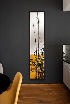 a painting hanging on the wall next to a table and chairs in a room with black walls