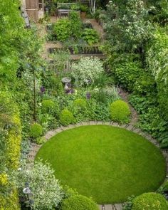 an aerial view of a garden with lots of trees and plants in the center, surrounded by greenery