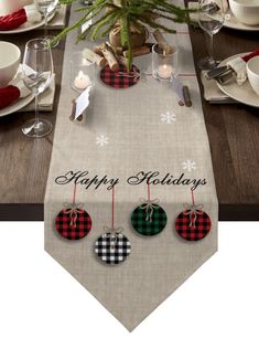 a christmas table runner with plaid ornaments on it