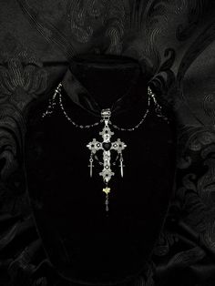 Choker consisting of a velvet band, rosary-style beading, black rose charms, and a customized cross charm featuring a rattlesnake vertebrate. Perfect for romantic goths. Romantic Goth Necklace, Handmade Punk Style Cross Jewelry, Adjustable Gothic Cross Pendant Jewelry, Black Cross Pendant Jewelry For Halloween, Gothic Cross Necklace For Festivals, Black Cross Jewelry For Halloween, Gothic Beaded Cross Jewelry, Handmade Black Jewelry For Concert, Handmade Black Jewelry For Concerts