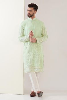 Green georgette kurta with all over geometric and floral embroidery. Paired with a pant.
Components: 2
Pattern: Embroidery
Type Of Work: Geometric, Floral
Neckline: Stand Collar
Sleeve Type: Full Sleeves
Fabric: Georgette
Color: Green
Other Details: 
Concealed half button placket
Occasion: Sangeet - Aza Fashions Light Green Kurta For Men, Designer Fitted Sherwani In Georgette, Fitted Georgette Sherwani For Designer Wear, Fitted Georgette Sherwani For Festive Occasions, Festive Fitted Georgette Sherwani, Elegant Long Sleeve Kurta With Geometric Embroidery, Traditional Fitted Sherwani In Georgette, Traditional Fitted Georgette Sherwani, Unstitched Long Sleeve Kurta With Geometric Embroidery