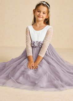 The Mae flower girl dress is a stunning A-line design that combines matte satin and delicate tulle with lace accents. Featuring an elegant illusion scoop neckline, long sleeves, and a stylish V-back with a zipper, it’s beautifully finished with charming bows, making it perfect for a fairytale wedding. Purple Flower Girl Dresses, Purple Flower Girl Dress, Military Ball Dresses, Sage Dress, Special Event Dresses, Ivory Flower Girl Dresses, Lace Bride, Tulle Flower Girl, Flower Girl Dresses Tulle