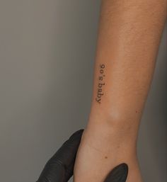 a person with a tattoo on their left arm and the word daddy written in black ink