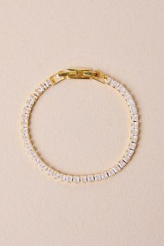 With a little something like the Lulus Perfectly Upscale Gold Rhinestone Tennis Bracelet on your wrist, everyone will know you're a luxe lady! Shiny, gold-toned metal shapes this stunning bracelet that has a slender design, with sparkling inset rhinestones that create a tennis bracelet-style silhouette. Clasp closures. Bracelet measures 5. 5" long. Man Made Materials. Imported. Lulus | Perfectly Upscale Gold Rhinestone Tennis Bracelet. Bracelet Style, Gold Rhinestone, Rhinestone Bracelet, Jewelry Inspo, Tennis Bracelet, Women's Summer Fashion, Gold Tone Metal, Fashion Bracelets, Jewelry Accessories