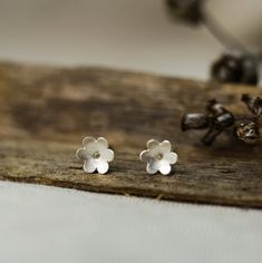 A pair of tiny flower earrings These earrings are made of 925 sterling silver and have a matte finish that makes them elegant and delicate. A gently hammered surface makes these studs every time different and unique. DETAILS: * Ø Diameter approx. 6 mm or 0.24 inch * Sterling silver earrings posts and butterfly backs * Matte finish All jewelry comes carefully and beautifully packed in a craft paper box, gift ready. You might also like these flowers: https://www.etsy.com/listing/694019223/black-fl Delicate Sterling Silver Flower Earrings For Gift, Delicate Sterling Silver Flower Earrings As Gift, Dainty Sterling Silver Flower Earrings For Anniversary, Dainty Sterling Silver Flower-shaped Earrings, Tiny Minimalist Flower Earrings, Dainty Nickel-free Flower Earrings For Anniversary, Tiny Sterling Silver Flower Earrings As Gift, Minimalist Flower Earrings In Sterling Silver, Minimalist Sterling Silver Flower Charm Earrings